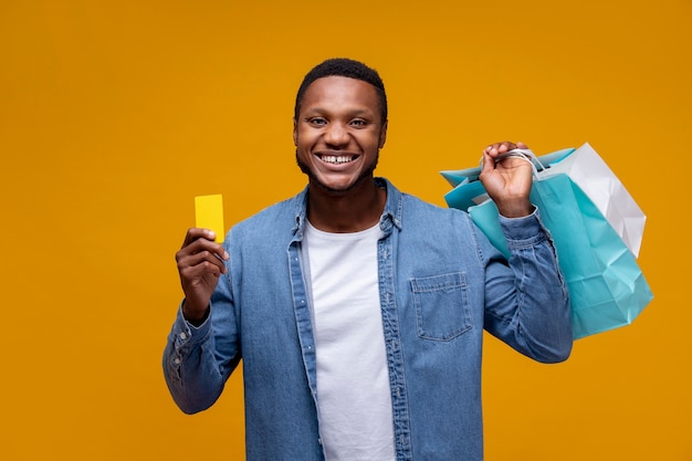 Smiley man holding paper bags medium shot