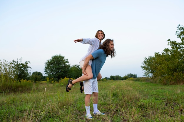 Free photo smiley man holding woman full shot