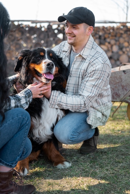 Smiley man petting cute dog