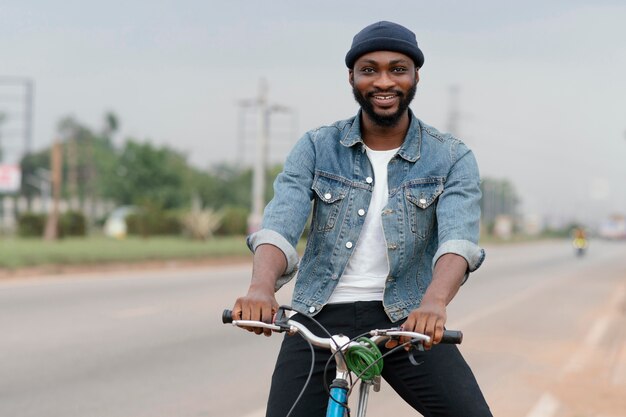 Smiley man posing on bicycle