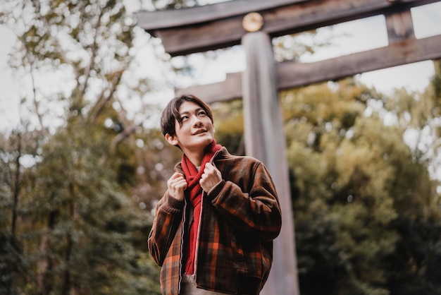 Smiley man posing outdoors in front of gate