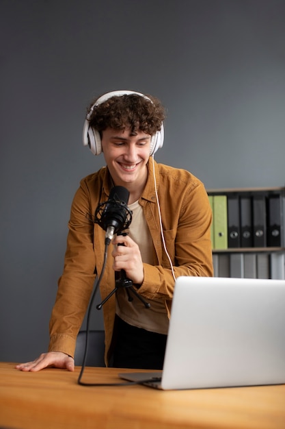 Smiley man recording podcast medium shot