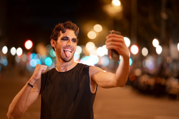 Smiley man taking selfie front view