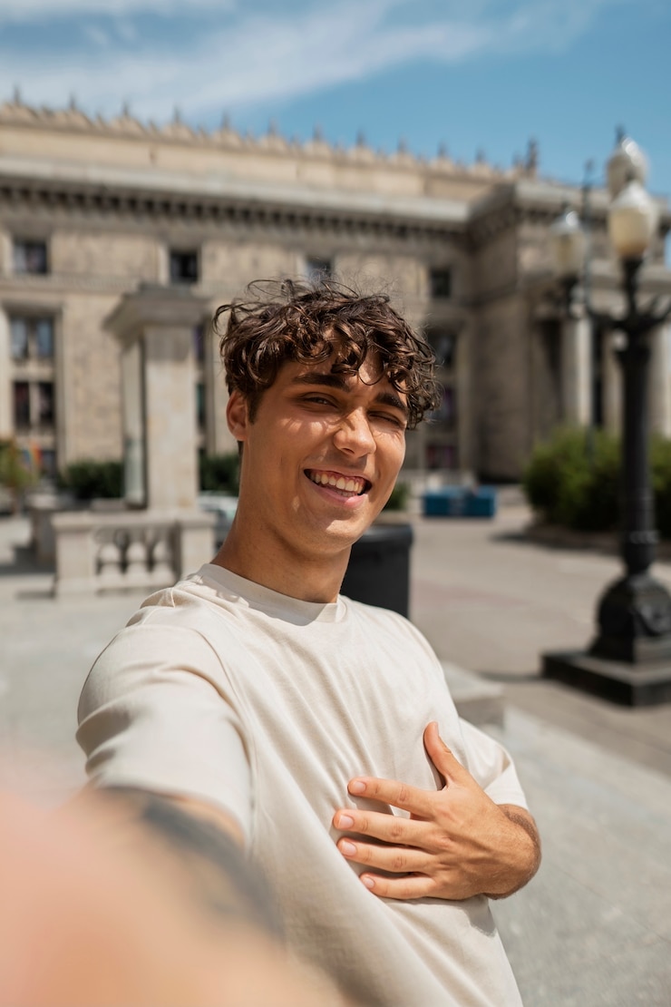 Free Photo smiley man taking selfie outside medium shot
