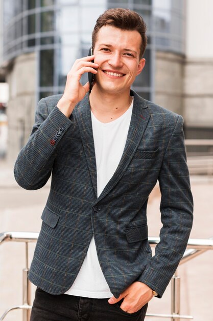 Smiley man talking on phone while on his way to work