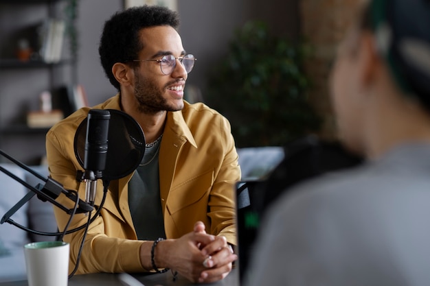 Free photo smiley man talking at podcast