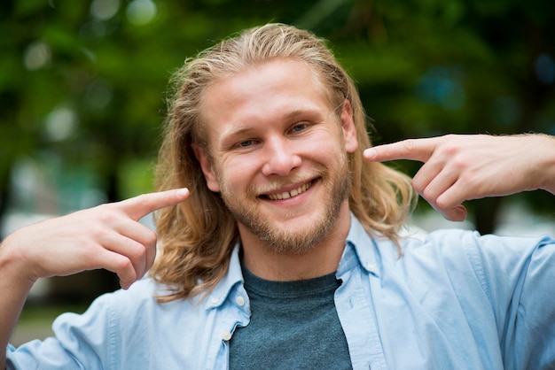 Free photo smiley man telling you to smile as well