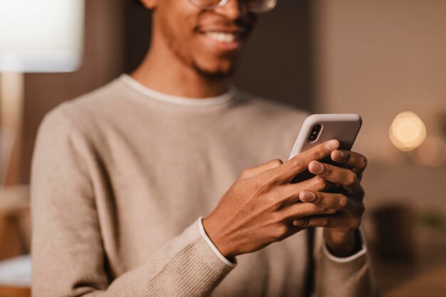 Smiley man using modern smartphone