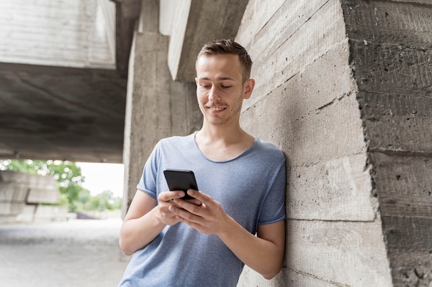 Uomo di smiley che verifica cellulare