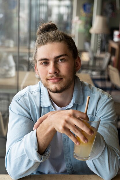 Smiley man with messy bun medium shot