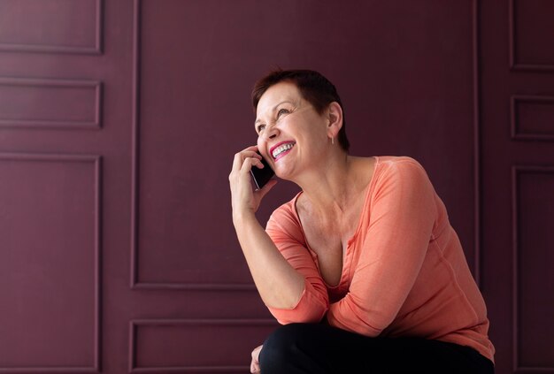 Smiley mature lady talking on the phone