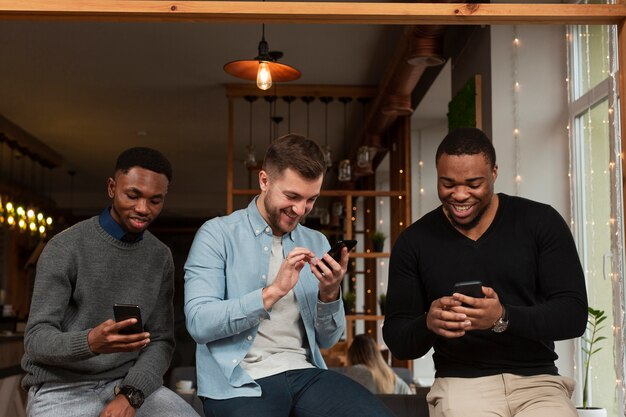 Smiley men checking phones