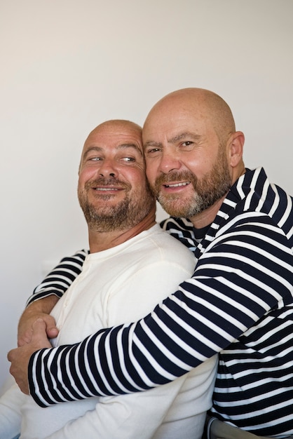 Free photo smiley men hugging medium shot