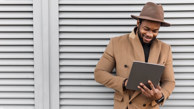 Smiley modern man looking on his tablet