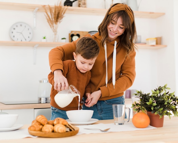 Smiley mom and son in the kitchen