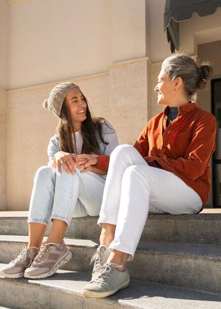 Smiley mother and daughter full shot