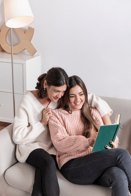 Smiley mother and daughter reading time