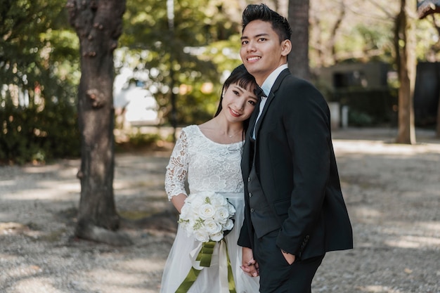 Free photo smiley newlyweds posing together outdoors