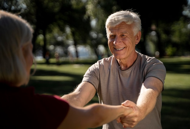 Smiley older couple exercising outdoors