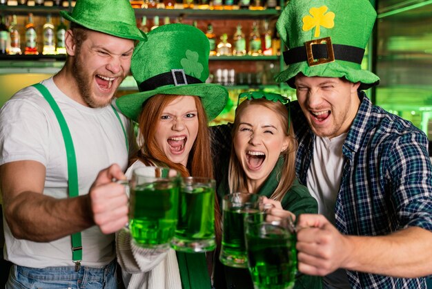 smiley people celebrating st. patrick's day at the bar
