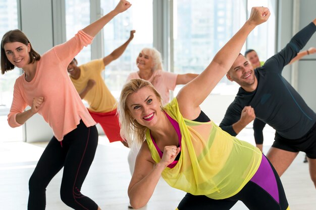 Smiley people having fun in zumba class