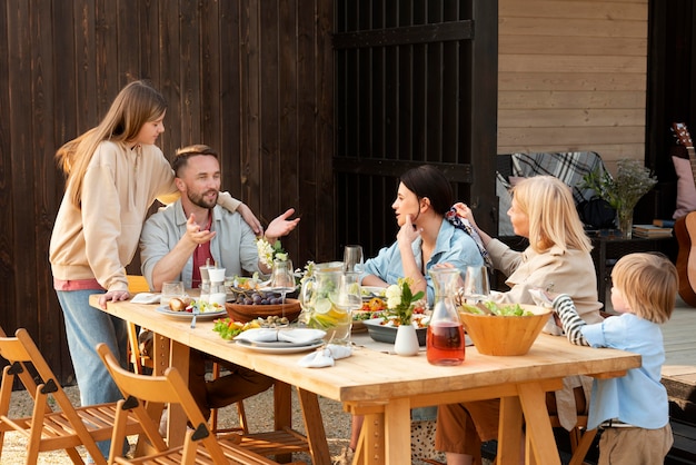 Free photo smiley people sitting at table medium shot