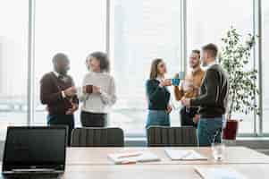 Free photo smiley people taking a coffee break from a meeting