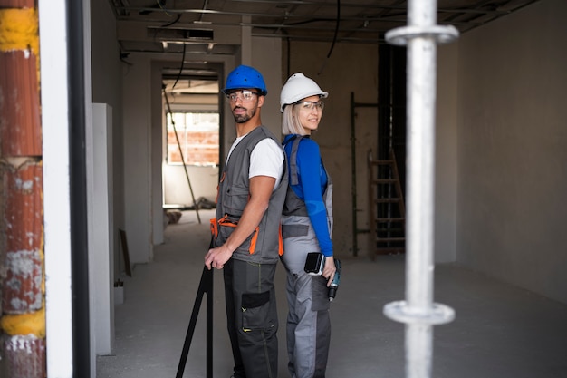 Free photo smiley people wearing safety helmets