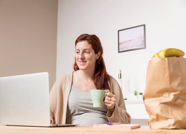 Smiley pregnant woman at home