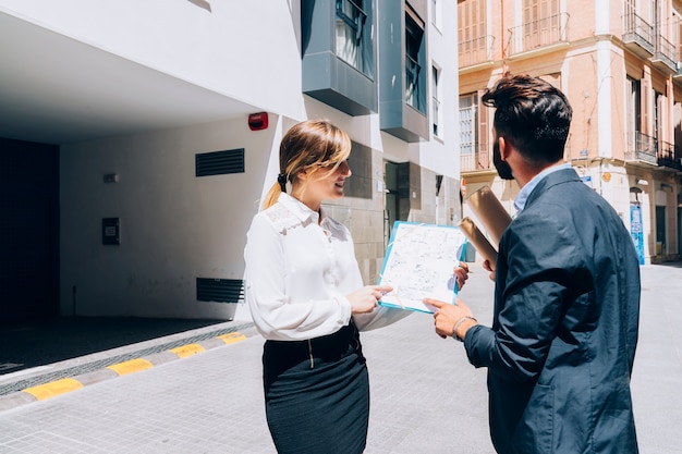 Smiley real estate agent talking to the architect