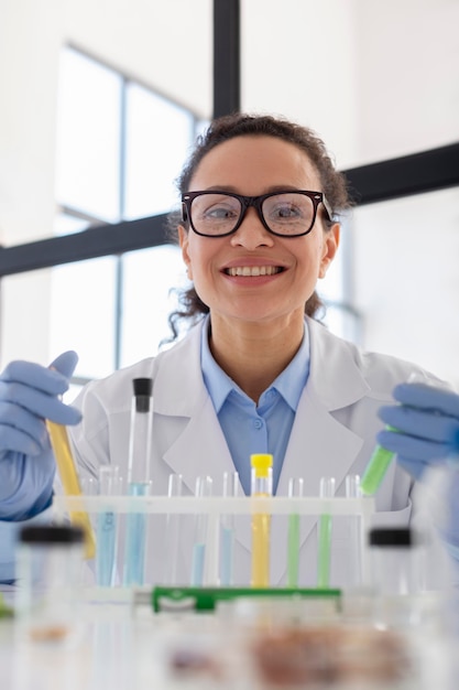 Smiley scientist holding tubes