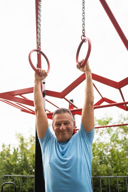 Smiley senior man exercising outdoors