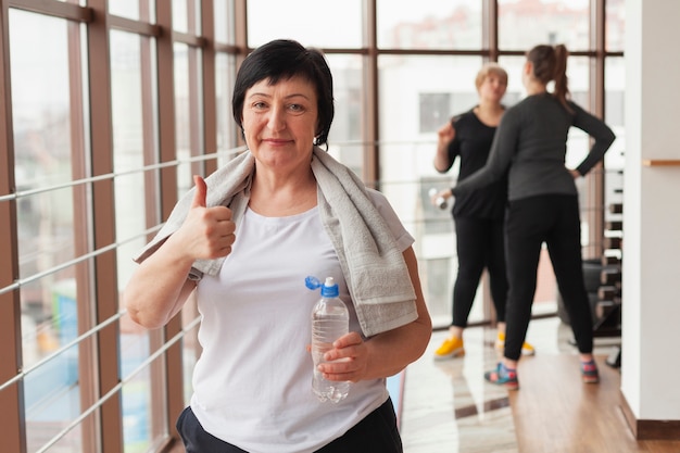 Foto gratuita donna senior di smiley che mostra segno giusto