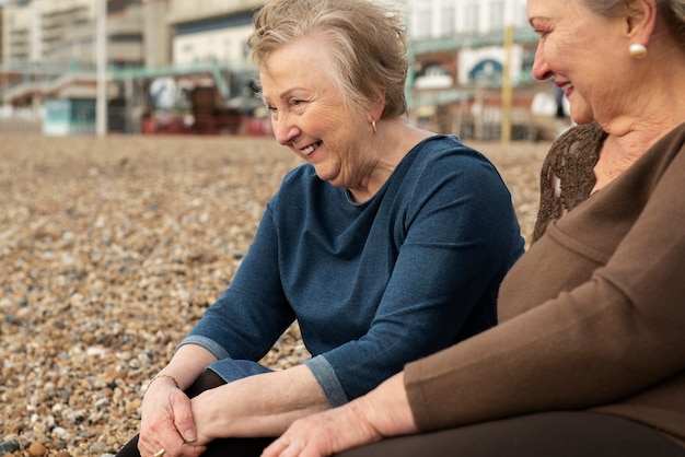 Smiley senior woman sitting on beach