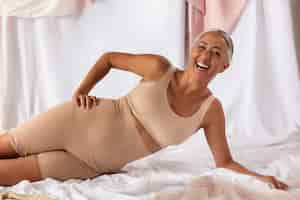 Free photo smiley senior woman wearing shapewear front view