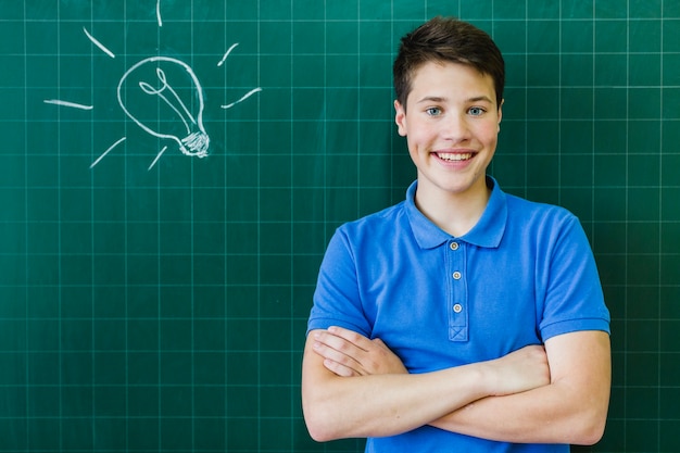 Smiley student in front of the blackboard