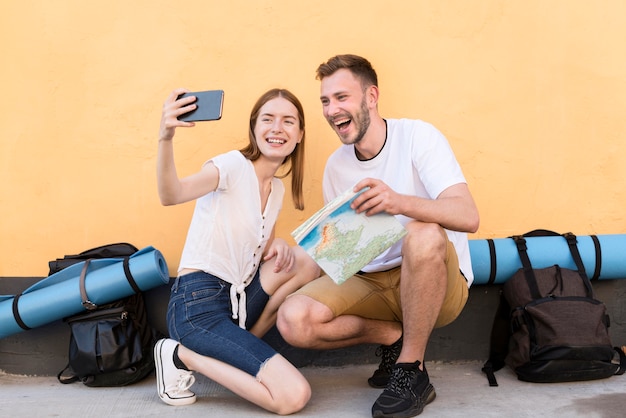 Smiley tourist couple taking a selfie together