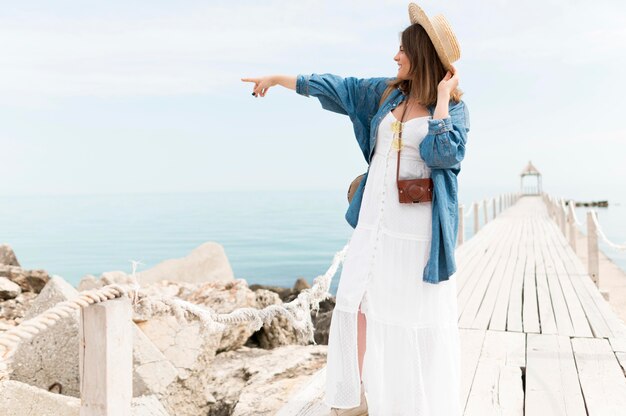 Smiley tourist pointing at something