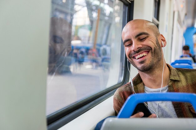 Smiley traveler with headphones in metro