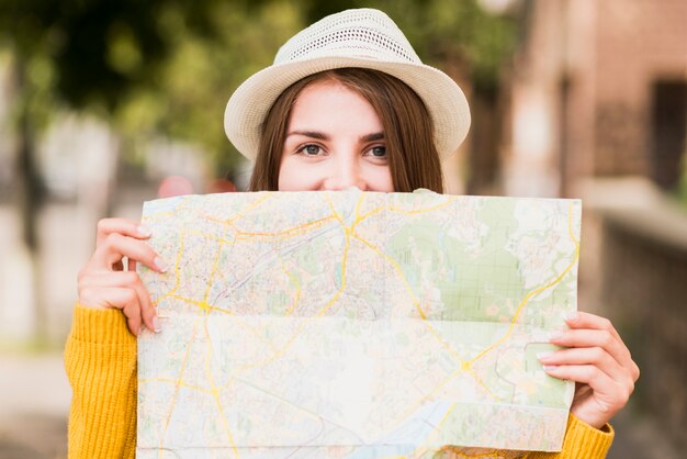 Smiley travelling woman holding map