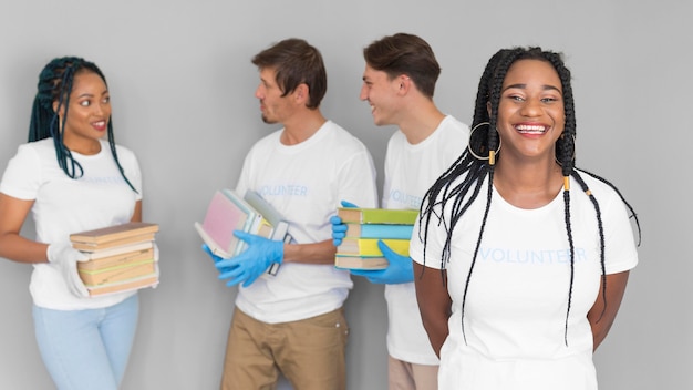 Smiley volunteering organization holding books for donations