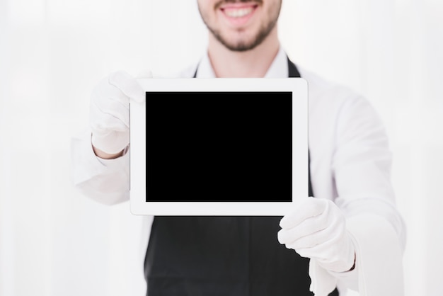 Smiley waiter showing tablet mock-up