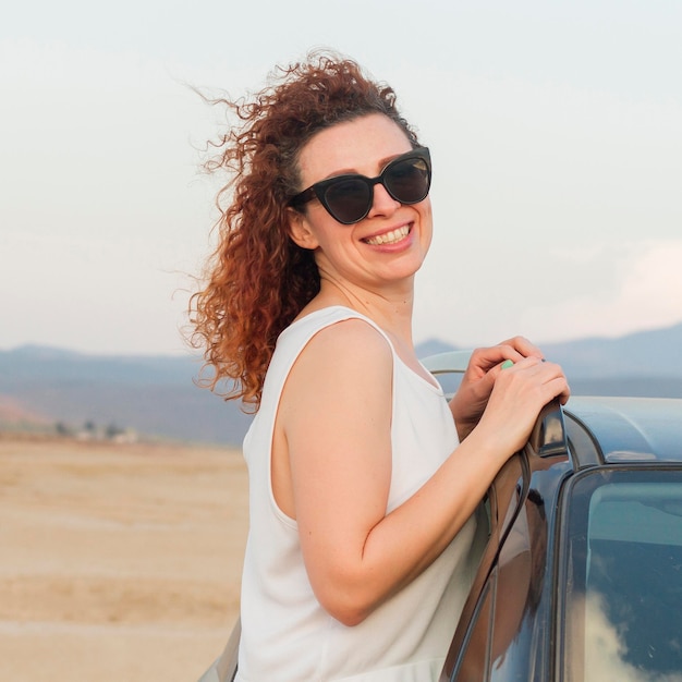 Smiley woman on car window