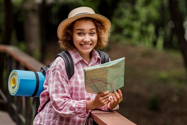 Smiley woman checking a map for a new destination