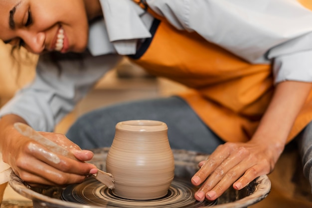 Smiley woman doing pottery