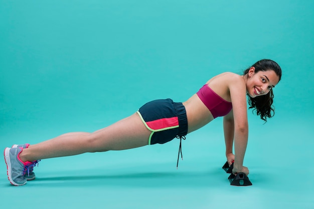 Smiley woman doing push ups