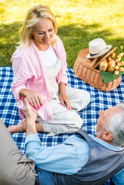 Smiley woman giving his hand to her man