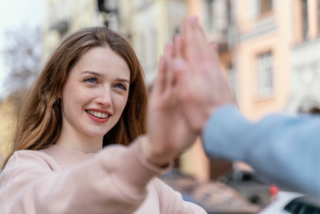 Smiley woman having fun with friends in the city