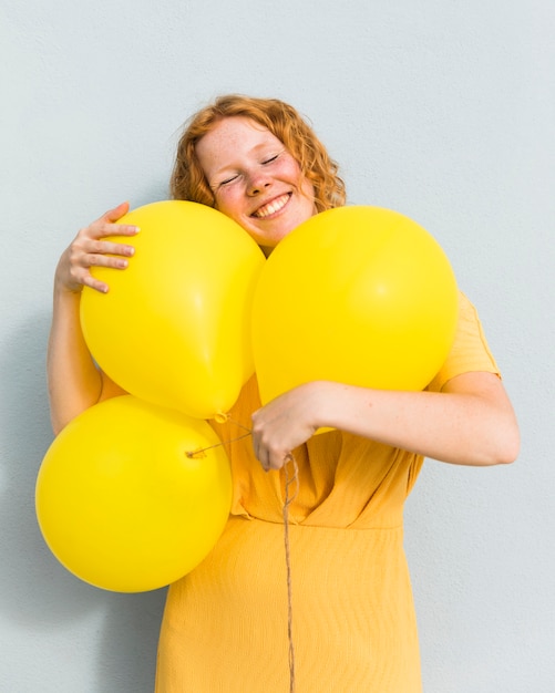 Free photo smiley woman holding balloons