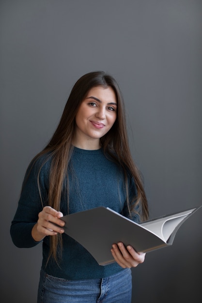 Smiley woman holding book front view